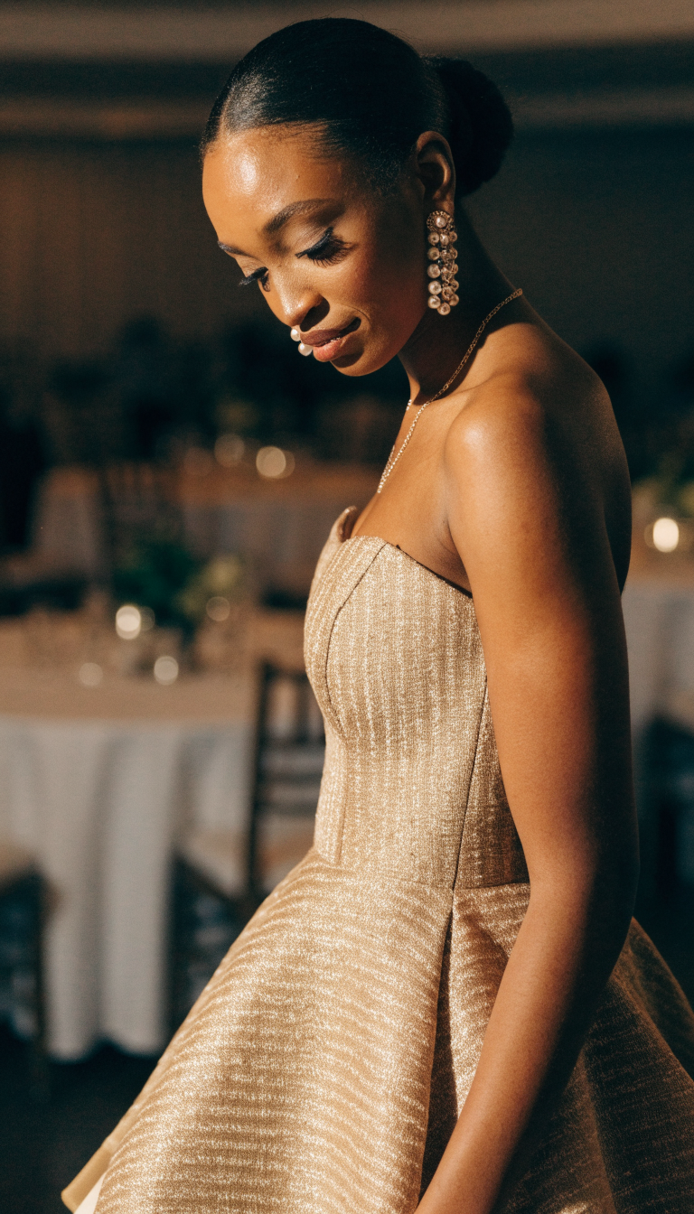 Bride wearing a fitted champagne gold aso-oke mermaid gown indoors
