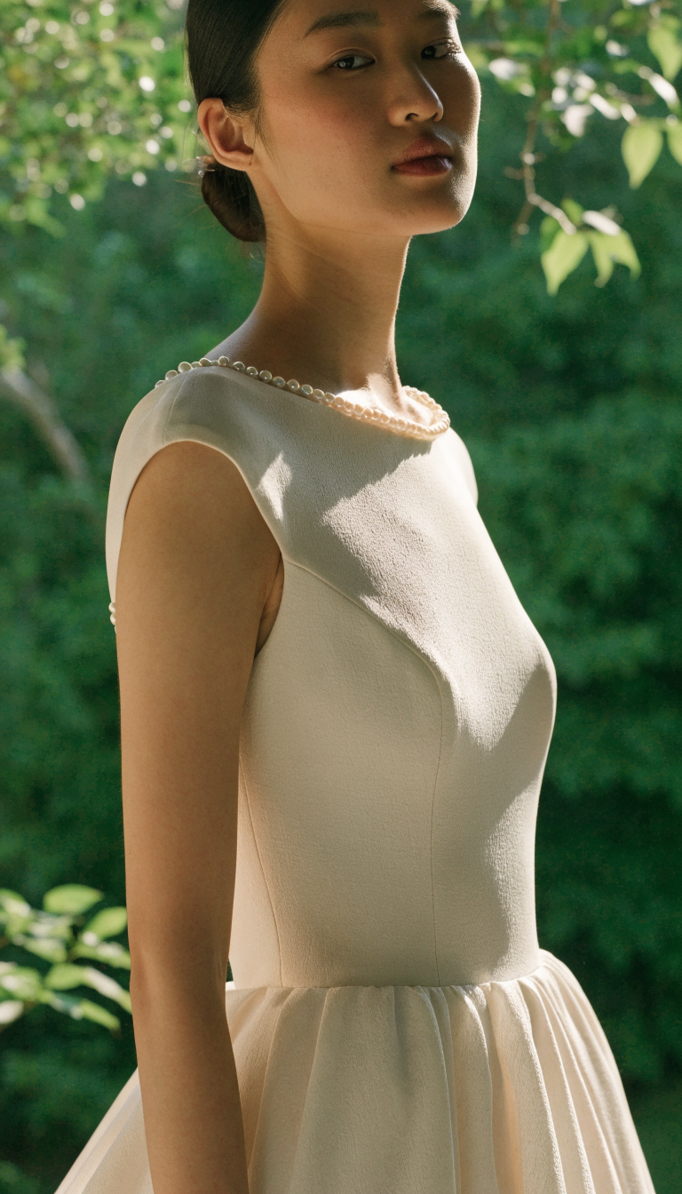Bateau neckline pearl wedding dress with subtle pearl detail in matte crepe