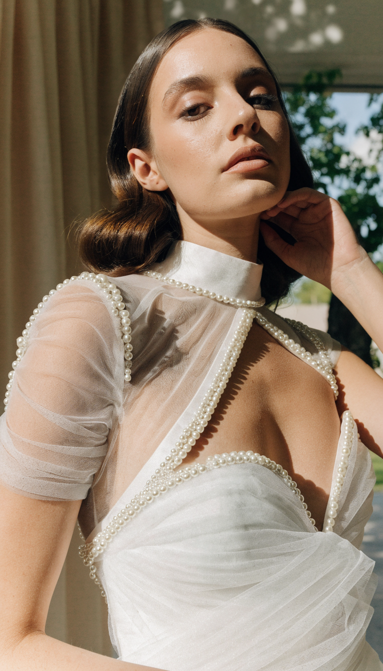 Asymmetrical cat eye neckline pearl wedding dress with pearl accents